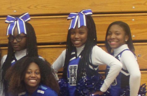 UACHS seniors Ajah Ricardo, Thara Dambreville and Imani White pose with other Lincoln cheerleaders. Several UACHS students cheer for other high schools that have cheerleading teams. Photo by Tatyana Reed