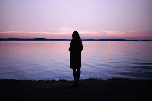 A woman looking at the beach.
